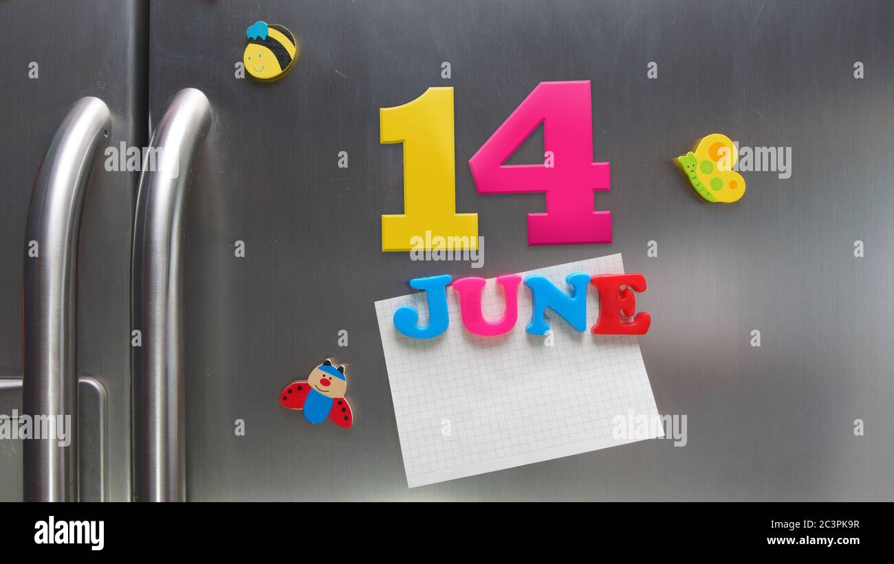 June 14 calendar date made with plastic magnetic letters holding a note of graph paper on door refrigerator Stock Photo