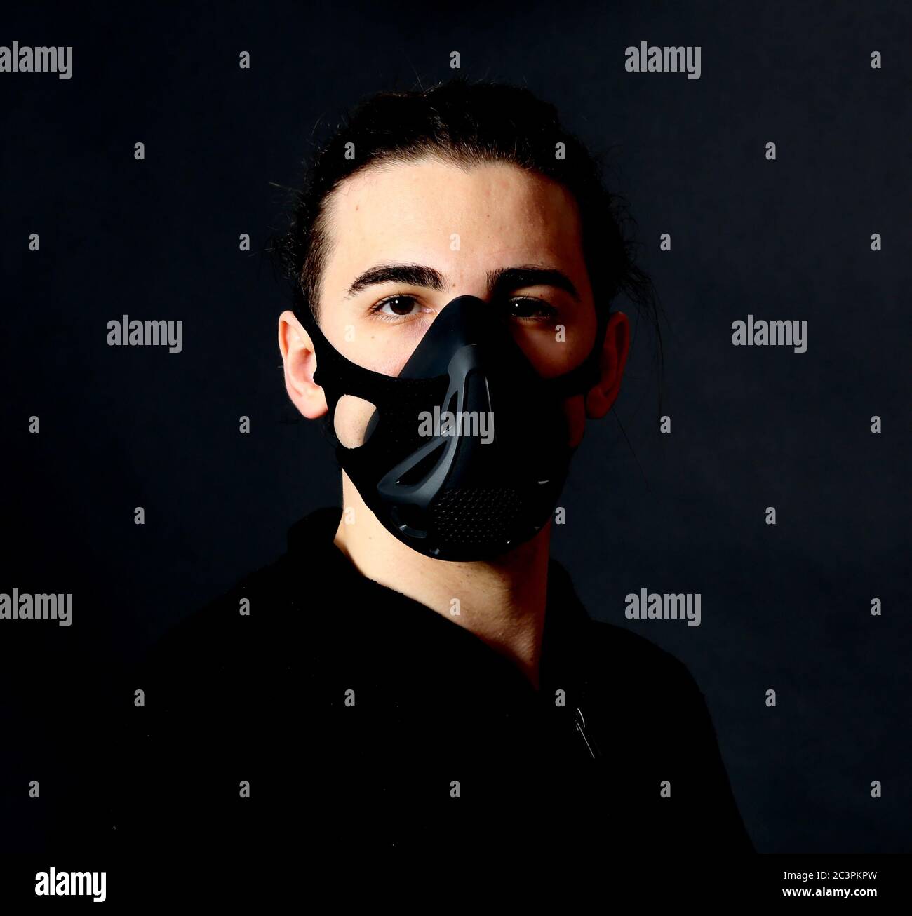 Young male model with mask posing in studio. Fantasy, Halloween, Sci-Fi ...