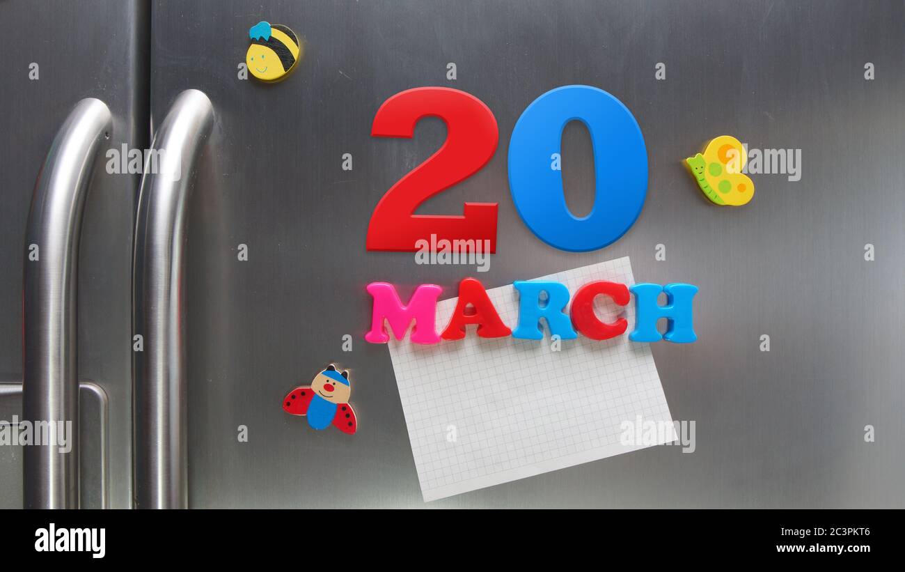 March 20 calendar date made with plastic magnetic letters holding a note of graph paper on door refrigerator Stock Photo