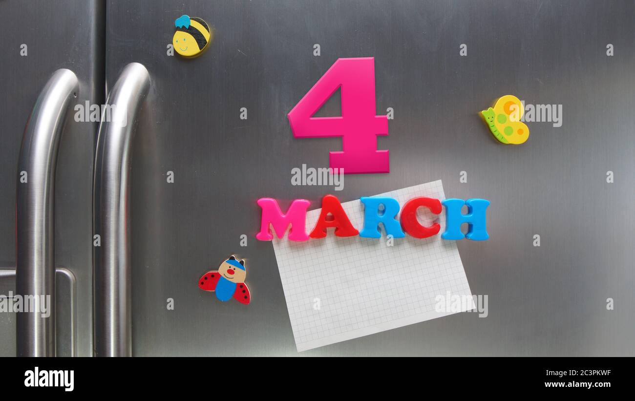 March 4 calendar date made with plastic magnetic letters holding a note of graph paper on door refrigerator Stock Photo