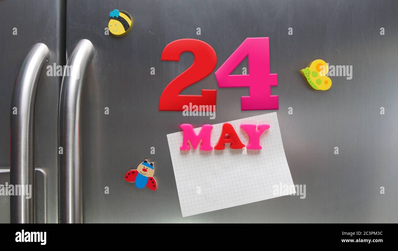May 24 calendar date made with plastic magnetic letters holding a note of graph paper on door refrigerator Stock Photo