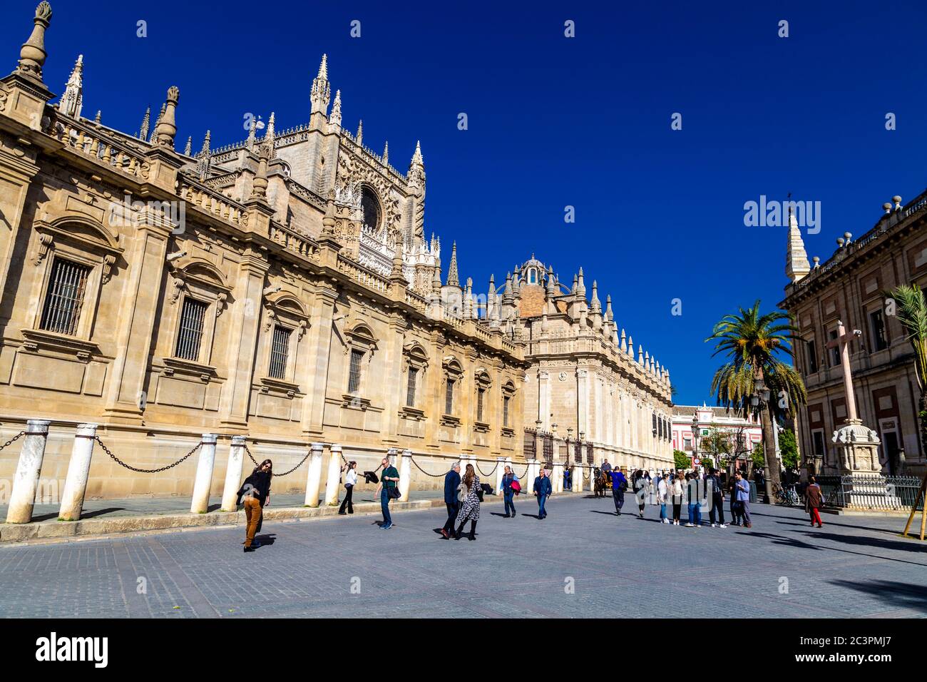 Left exterior of the 16th century Seville Cathedral (Cathedral of Saint Mary of the See), right General Archives of the Indies, Seville, Spain Stock Photo