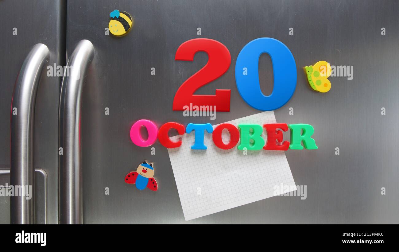 October 20 calendar date made with plastic magnetic letters holding a note of graph paper on door refrigerator Stock Photo