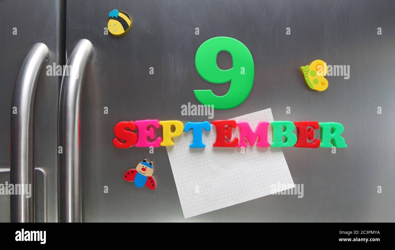 September 9 calendar date made with plastic magnetic letters holding a note of graph paper on door refrigerator Stock Photo