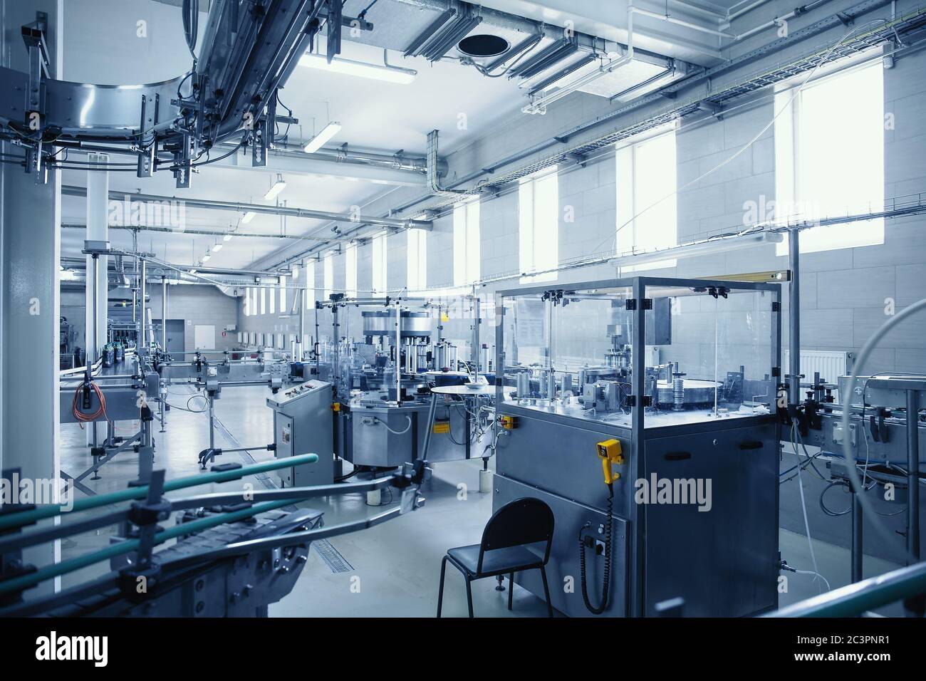 Industrial interior of beverage factory, blue toned. Food and drink production manufacturing. Stock Photo