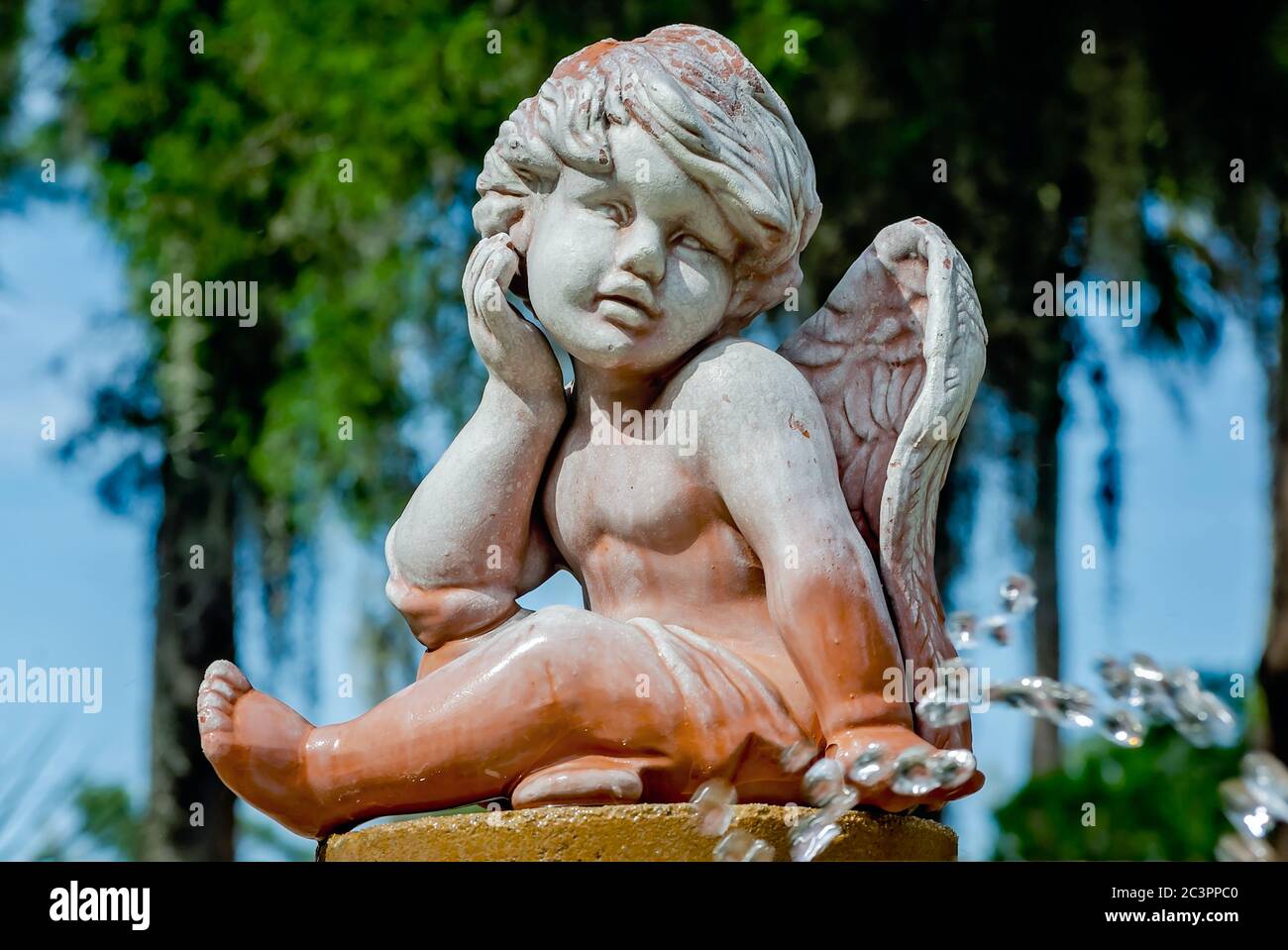 A cherub sits atop a fountain in the garden at Ponce de Leon’s Fountain of Youth Archaeological Park, Sept. 6, 2019, in St. Augustine, Florida. Stock Photo