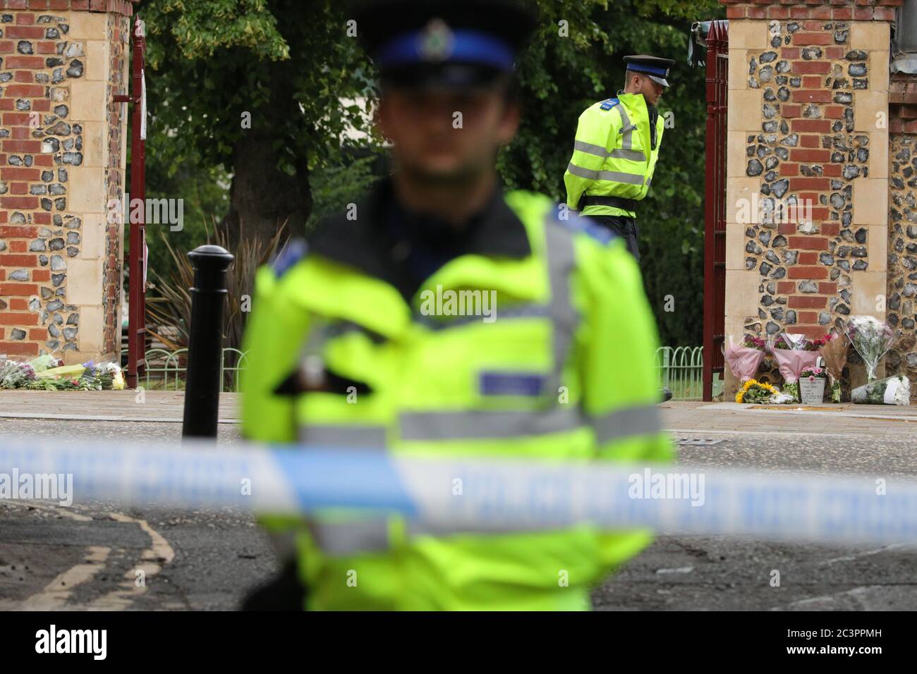 Reading, Britain. 21st June, 2020. Police officers are seen behind a police cordon at an entrance to Forbury Gardens where stabbings took place in Reading, Britain, on June 21, 2020. Britain's counter-terrorism police said Sunday that the stabbing incident taking place in southern England's town of Reading on Saturday night 'has now been declared a terrorist incident.' Credit: Tim Ireland/Xinhua/Alamy Live News Stock Photo