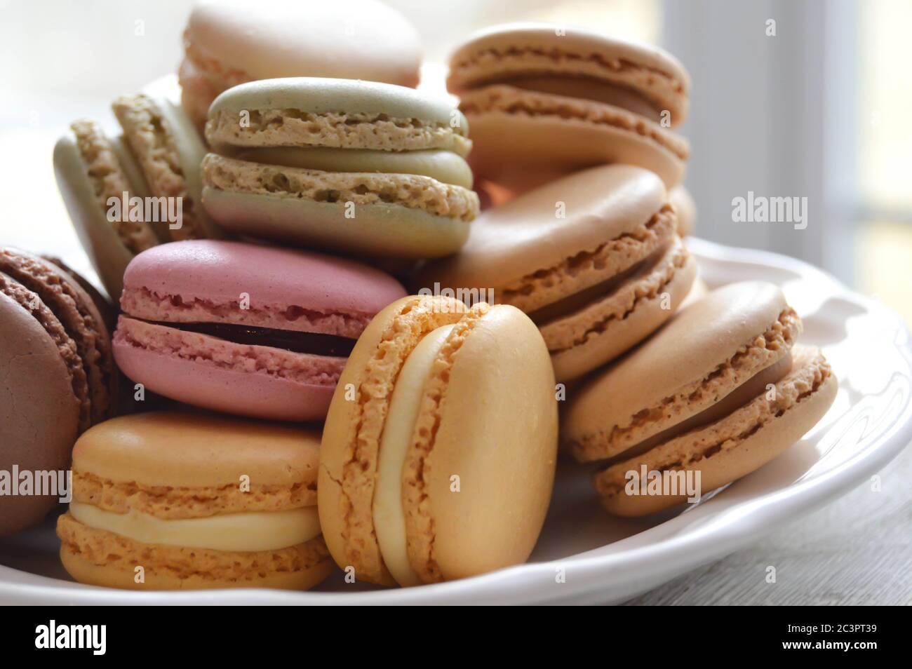 pastel macarons on a white plate Stock Photo - Alamy