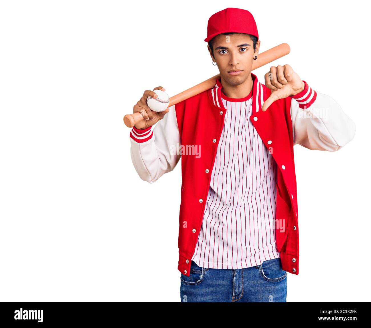 Young african amercian man playing baseball holding bat and ball with
