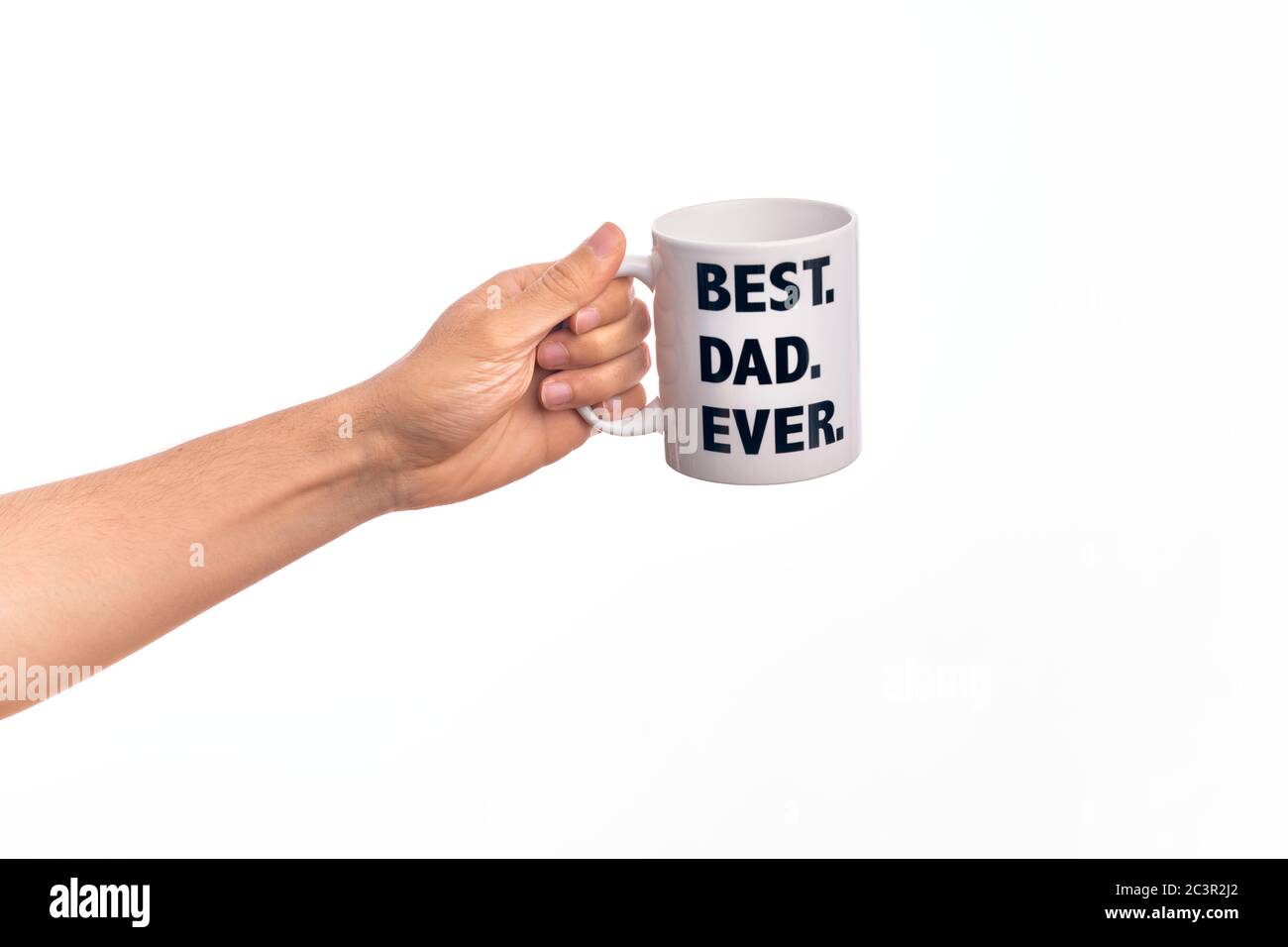 Hand of caucasian young man holding cup of coffee with best dad ever message over isolated white background Stock Photo