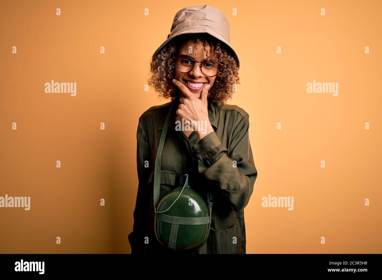 Young african american tourist woman on vacation wearing explorer hat ...