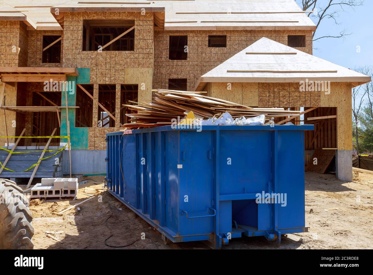 Truck loading a full recycling container trash dumpsters being with