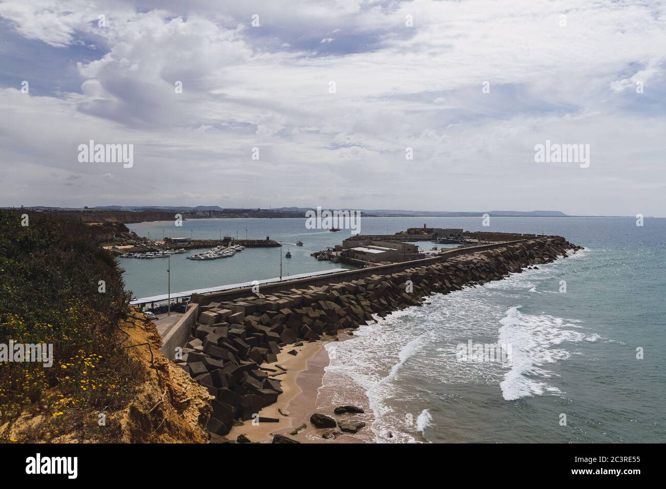 Landscape of the sea surrounded by rocks under a cloudy sky and ...