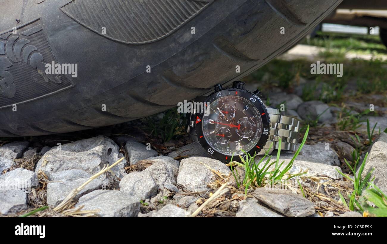 chronograph Tissot under the wheels of a car Krasnodar,Russia-20.06.2020. Stock Photo