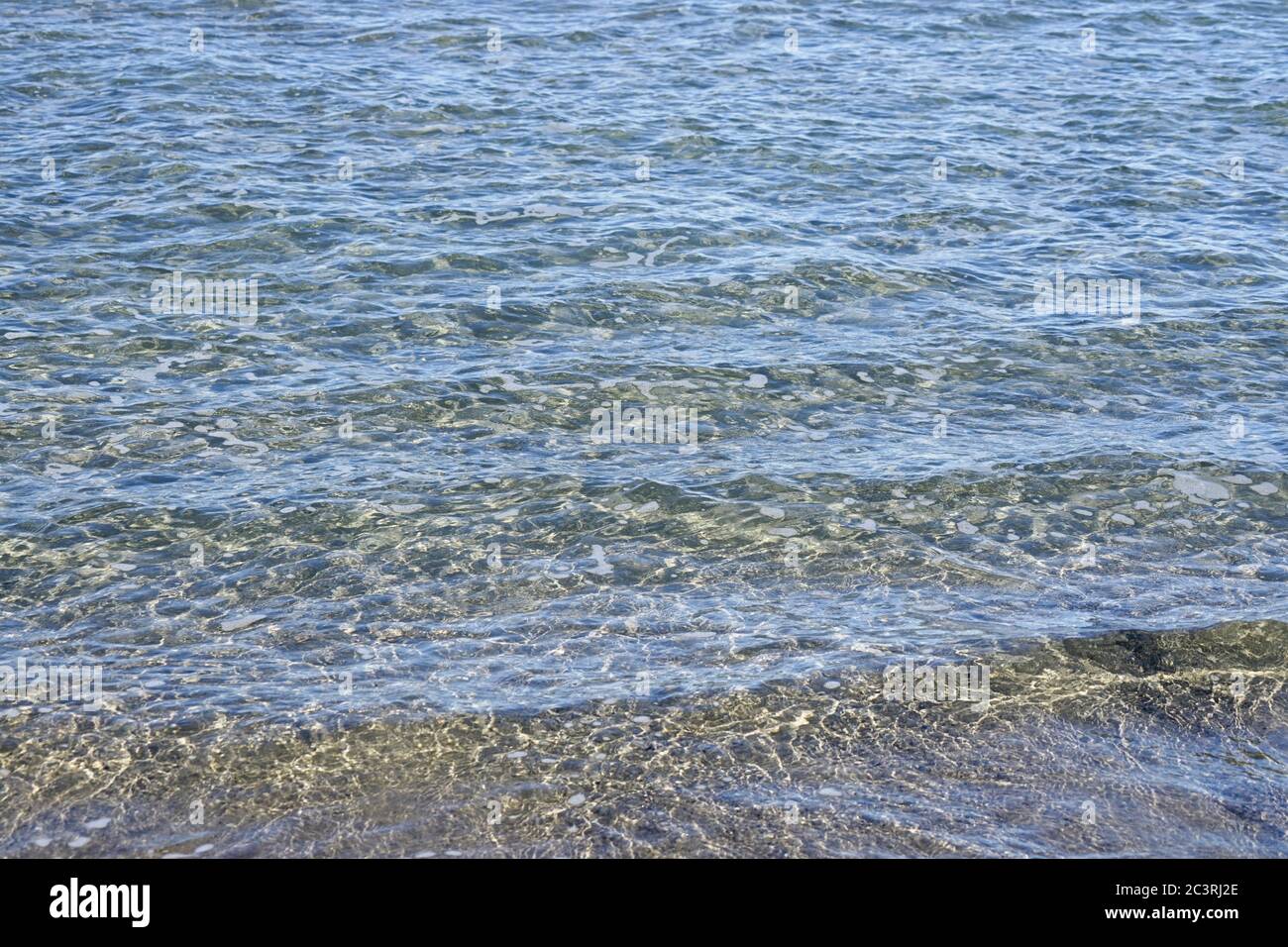 Ripples and light reflections on shallow sea water surface Stock Photo ...