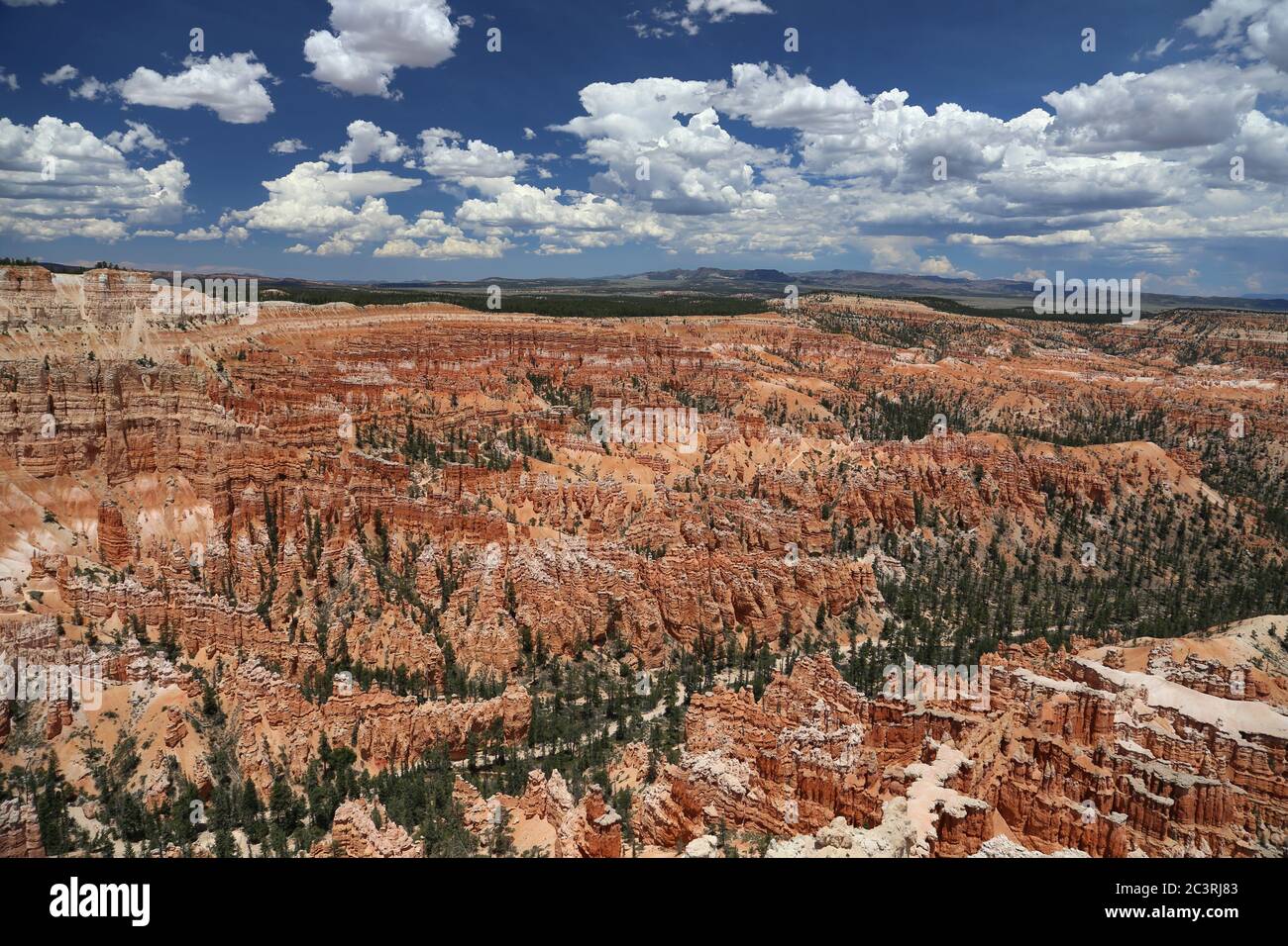 view of the amphitheater of Bryce Canyon National Park under a fair weather cloud and blue sky Stock Photo
