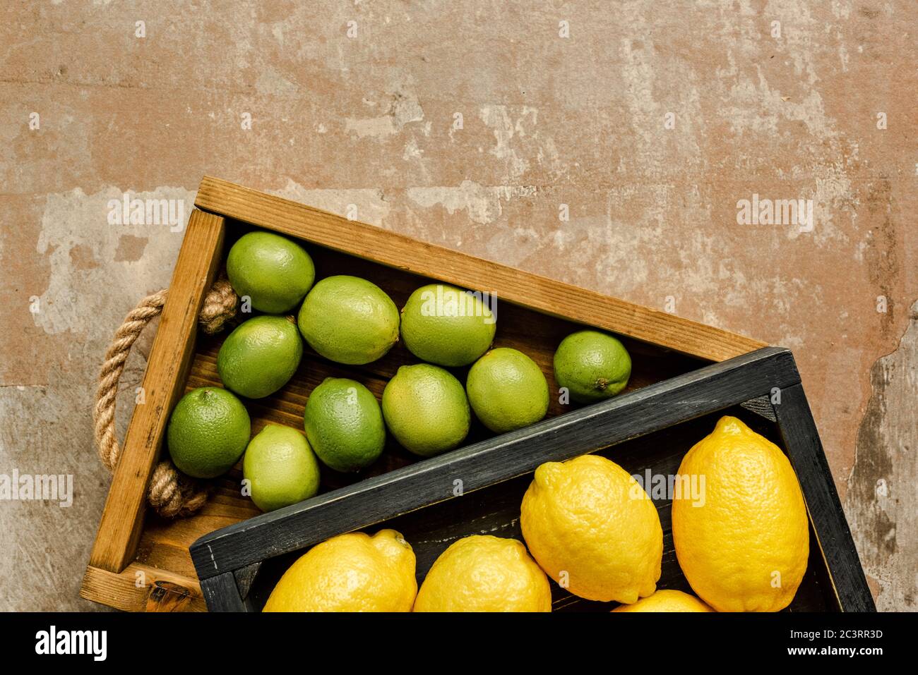 top view of lemons and limes in wooden boxes on weathered surface Stock ...