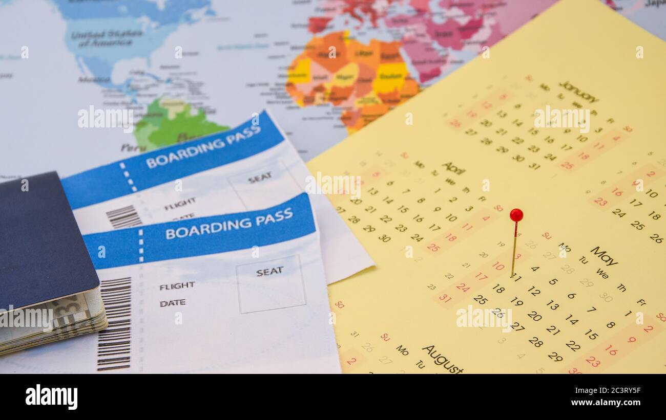 passport, boarding pass over map. travel concept. on calendar with pins Stock Photo