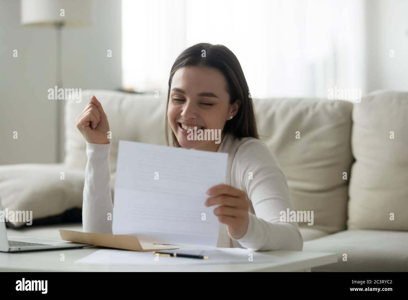 Student read letter about getting scholarship university admission feels happy Stock Photo