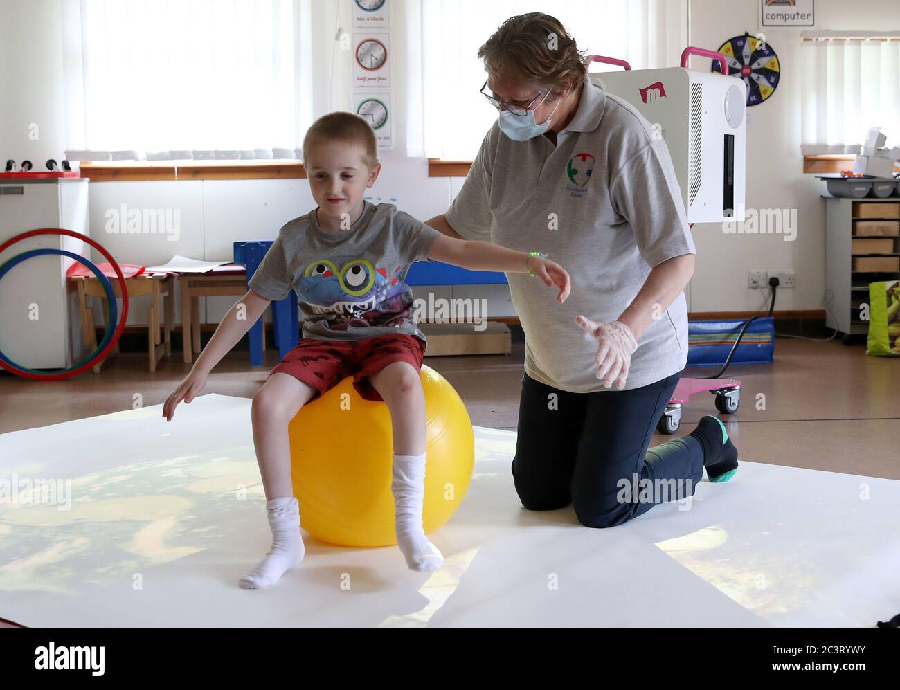 Callum McMichael alongside Paediatric Physiotherapist Kath Brimlow as he takes part in 1:1 session supporting development of posture and movement skills at the Craighalbert Centre. Coronavirus adaptations have been installed at the Scottish Centre for Children with Motor Impairments, Craighalbert Centre, Cumbernauld, as Scotland continues gradually lifting coronavirus lockdown measures. Stock Photo