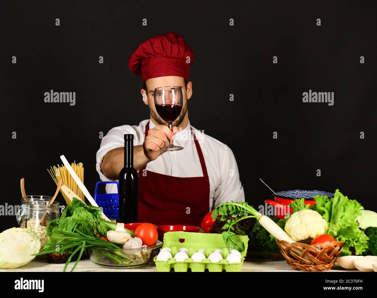 Sommelier and italian drink concept. Cook with thoughtful face in burgundy uniform smells luxury drink. Chef holds glass of red wine. Man with beard i Stock Photo Alamy