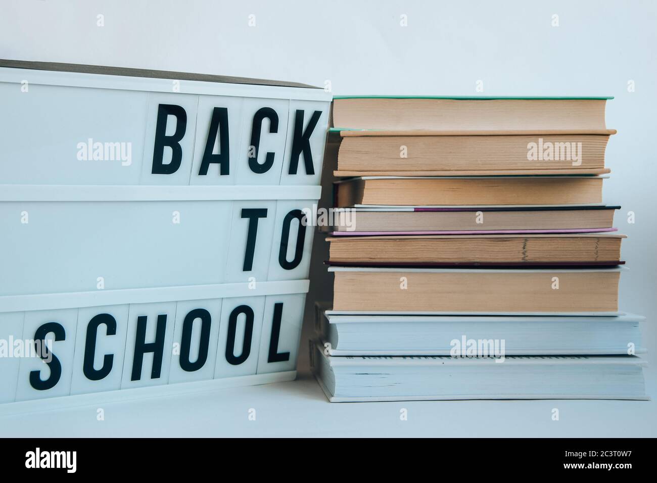 lightbox with BACK TO SCHOOL text and books on white background Stock Photo