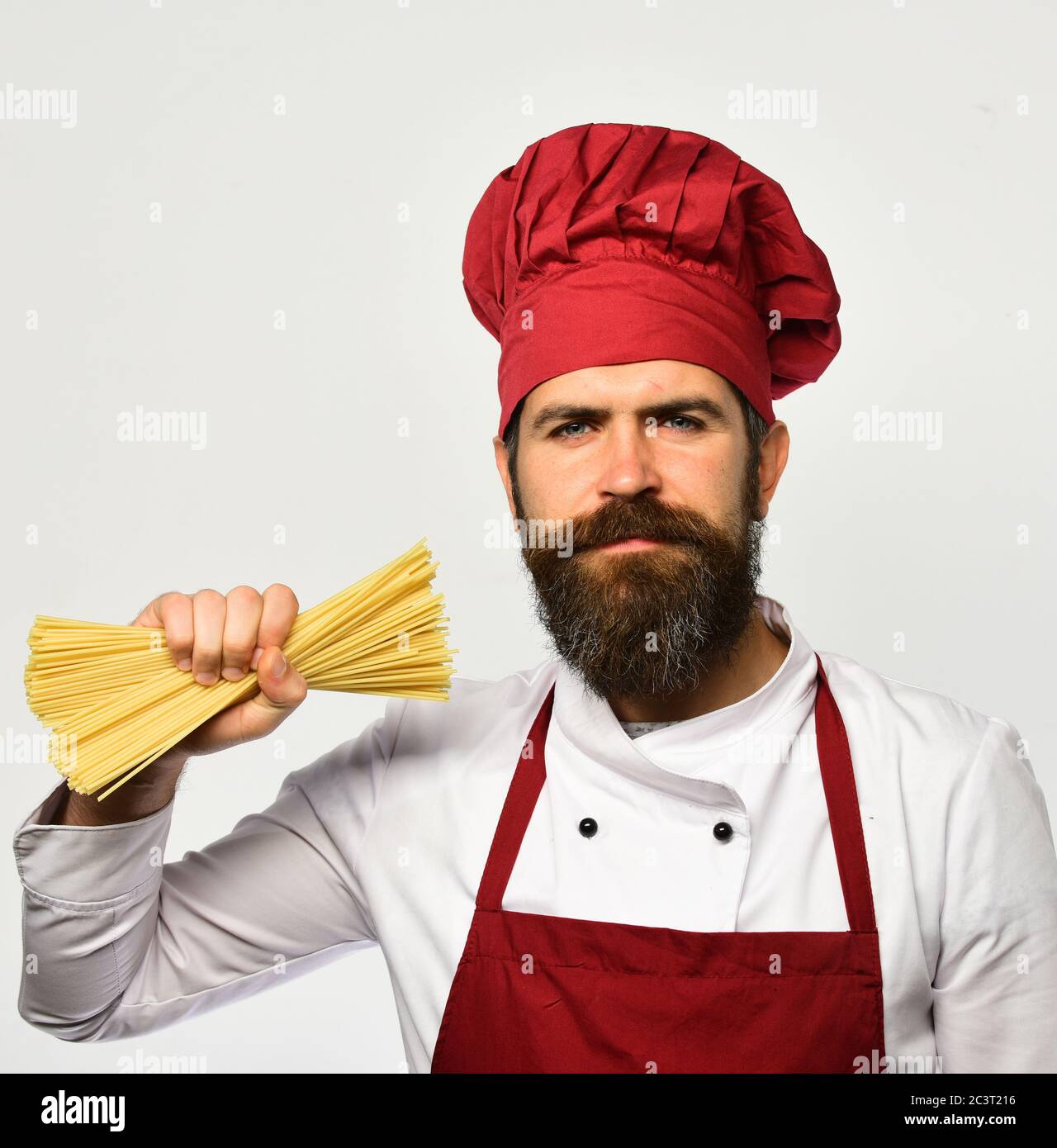 Catering and italian food concept. Chef holds bunch of spaghetti in ...