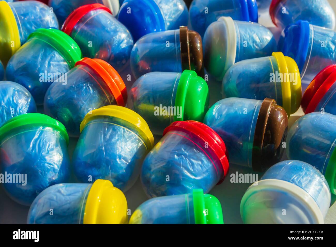 Blue shoe covers in individual capsules with multi-colored caps. Disposable shoe covers. Protection concept Stock Photo