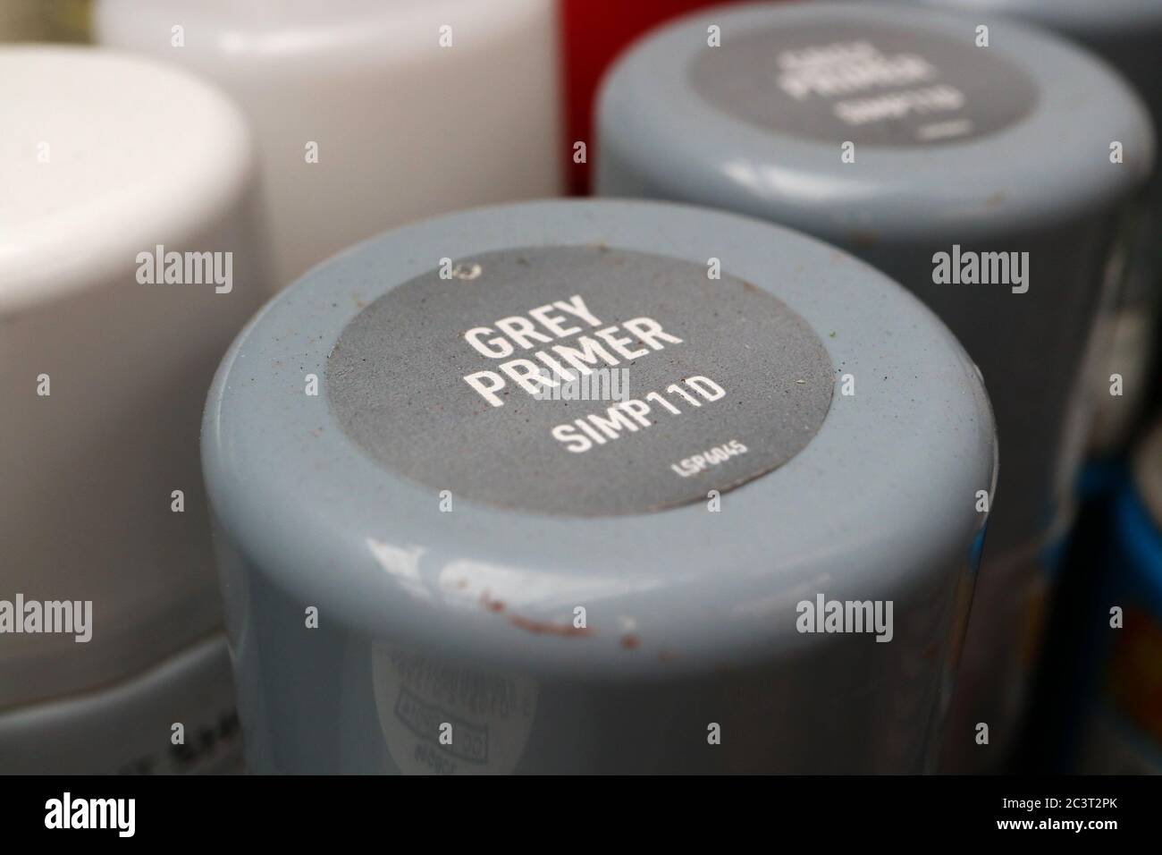 cans of grey primer in a garage workshop in the uk Stock Photo
