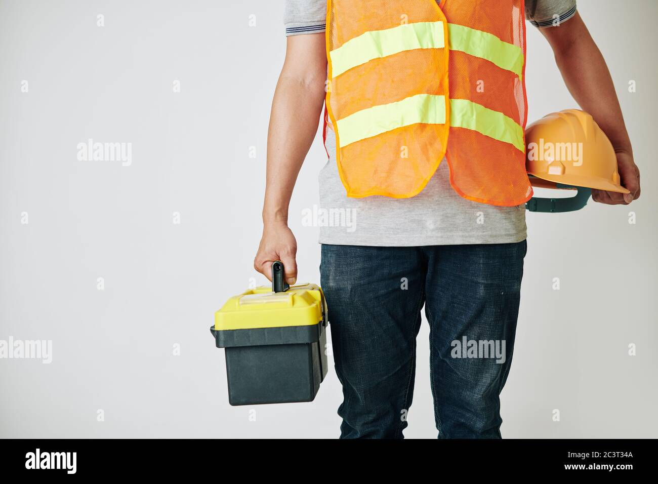 Cropped image of construction worker with toolbox and hardhat in his hands ready for work Stock Photo