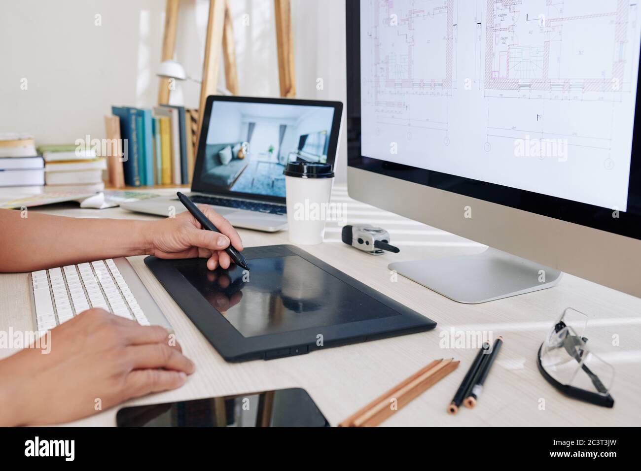 Cropped image of architect working at office desk and using graphic tablet  when drawing house blueprint Stock Photo - Alamy