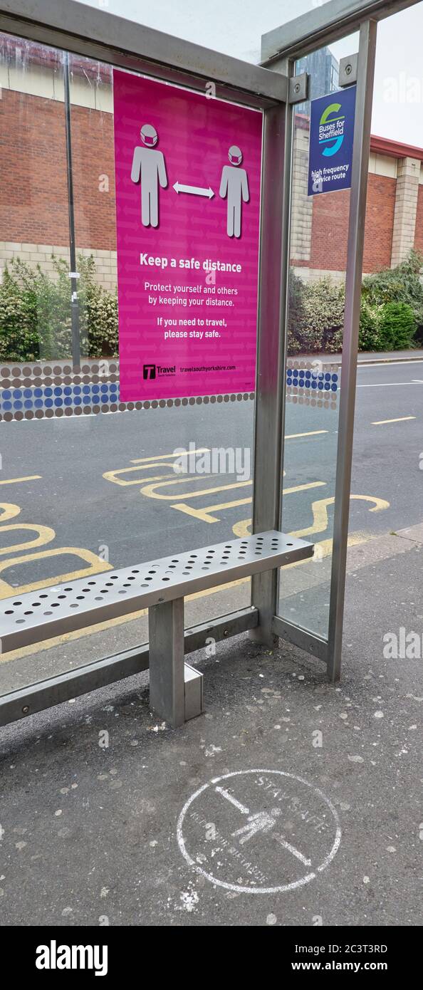 Keep a safe distance posters and pavement markings at bus stop in South