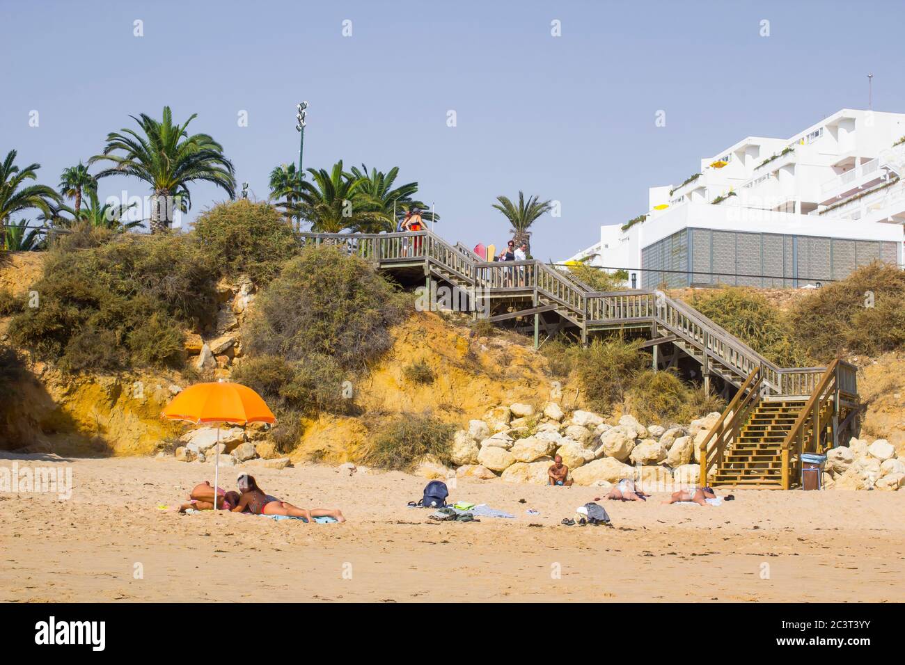 3 October 2018 A view along Oura Praia Beach in Albuferia Portugal on the Algarve with its hotels sun beds sand and holidaymakers Stock Photo