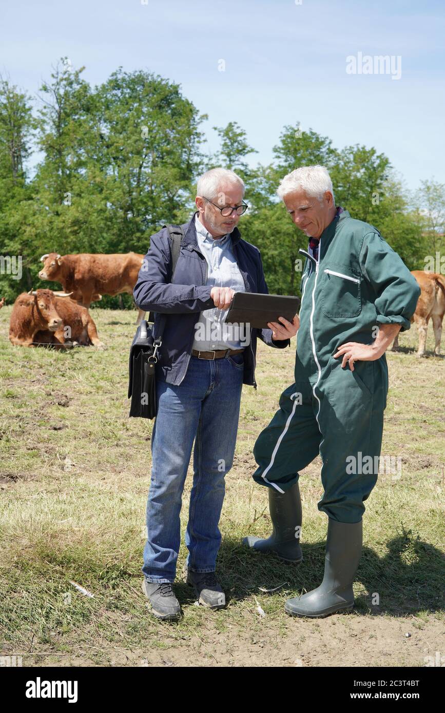 Farmer meeting with financial counseller in farm Stock Photo