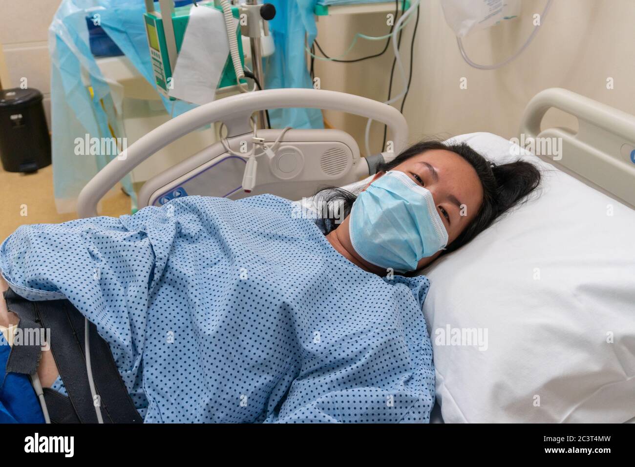 Young Asian Chinese lady in Contraction pain on hospital labour room
