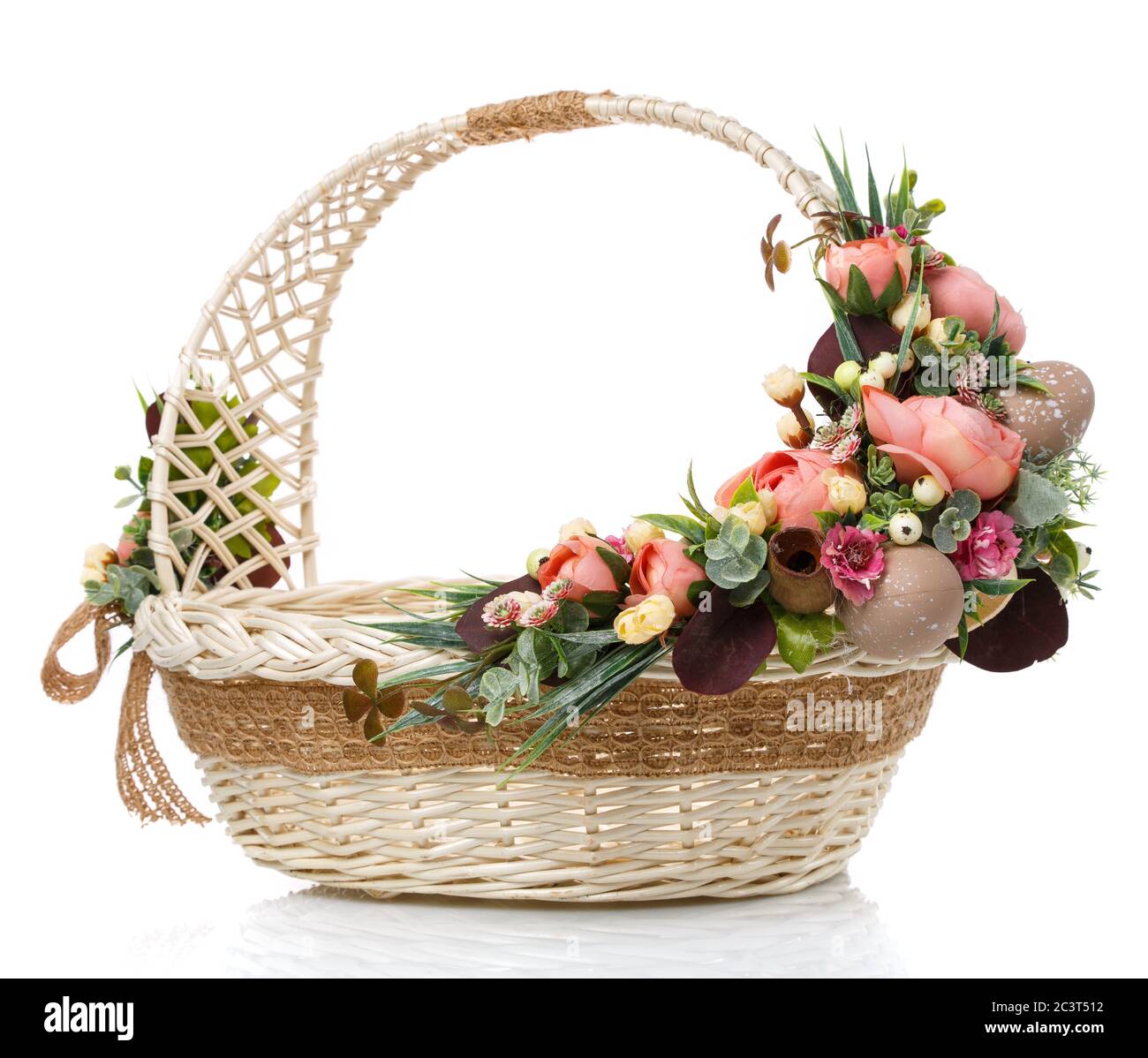 Wicker design baskets are decorated with a floral arrangement for Easter.  On a white background Stock Photo - Alamy