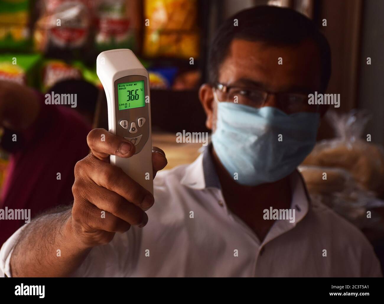 Showing Thermal Forehead Scanner Gun or digital thermometer Stock Photo