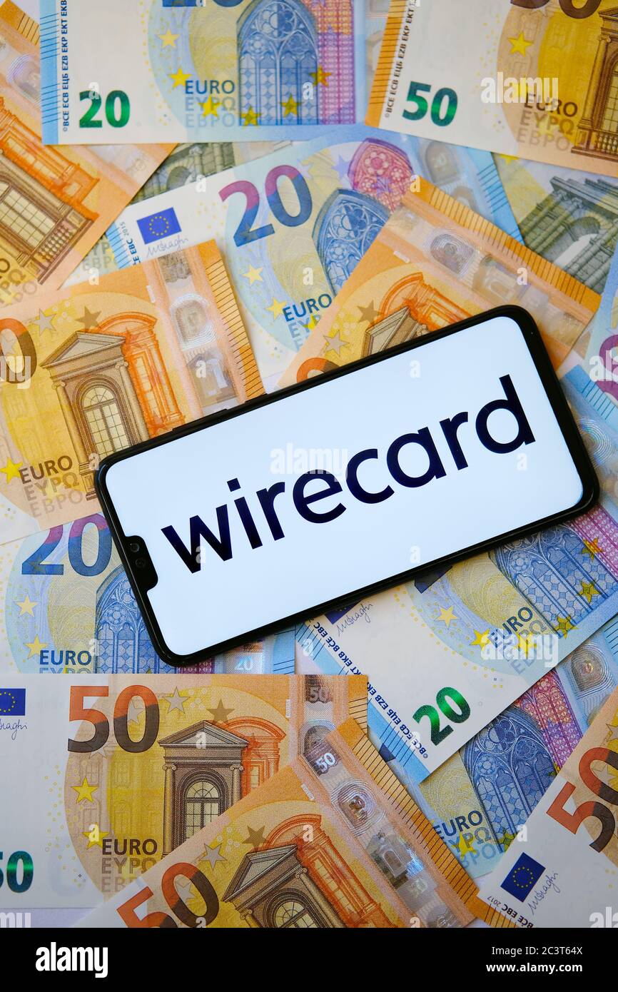 Wirecard new logo on smartphone and euro banknotes on the blurred background. Stock Photo