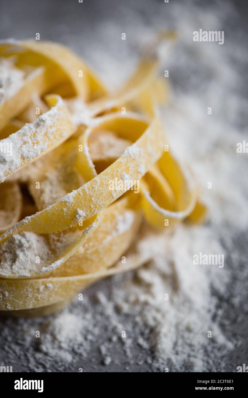 Homemade tagliatelle pasta on rustic board Stock Photo
