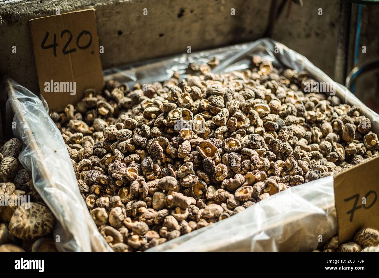 Box contains dry mushroom for sell with price tag Stock Photo