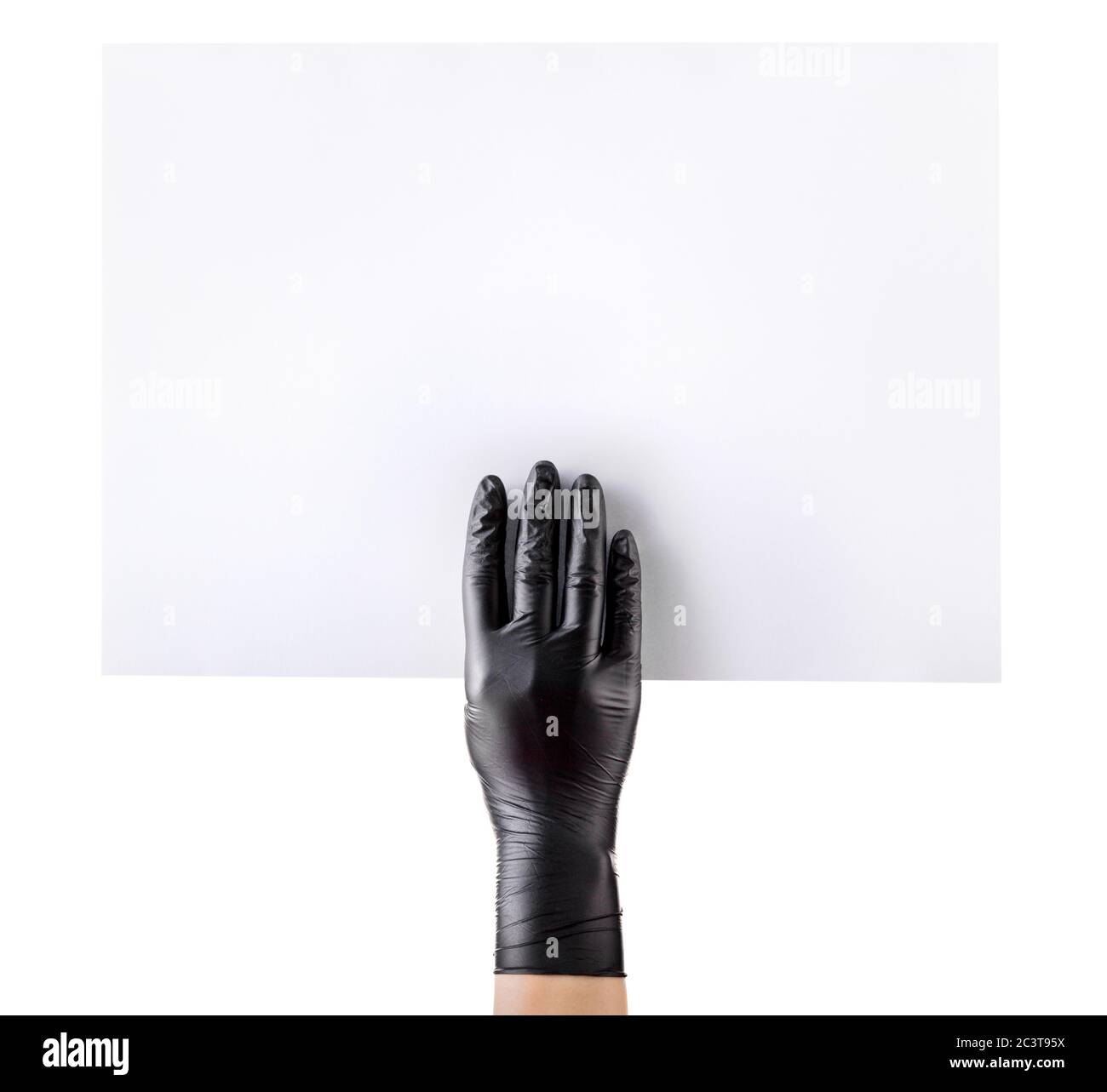 Hand in black gloves holding blank cardboard isolated on white Stock