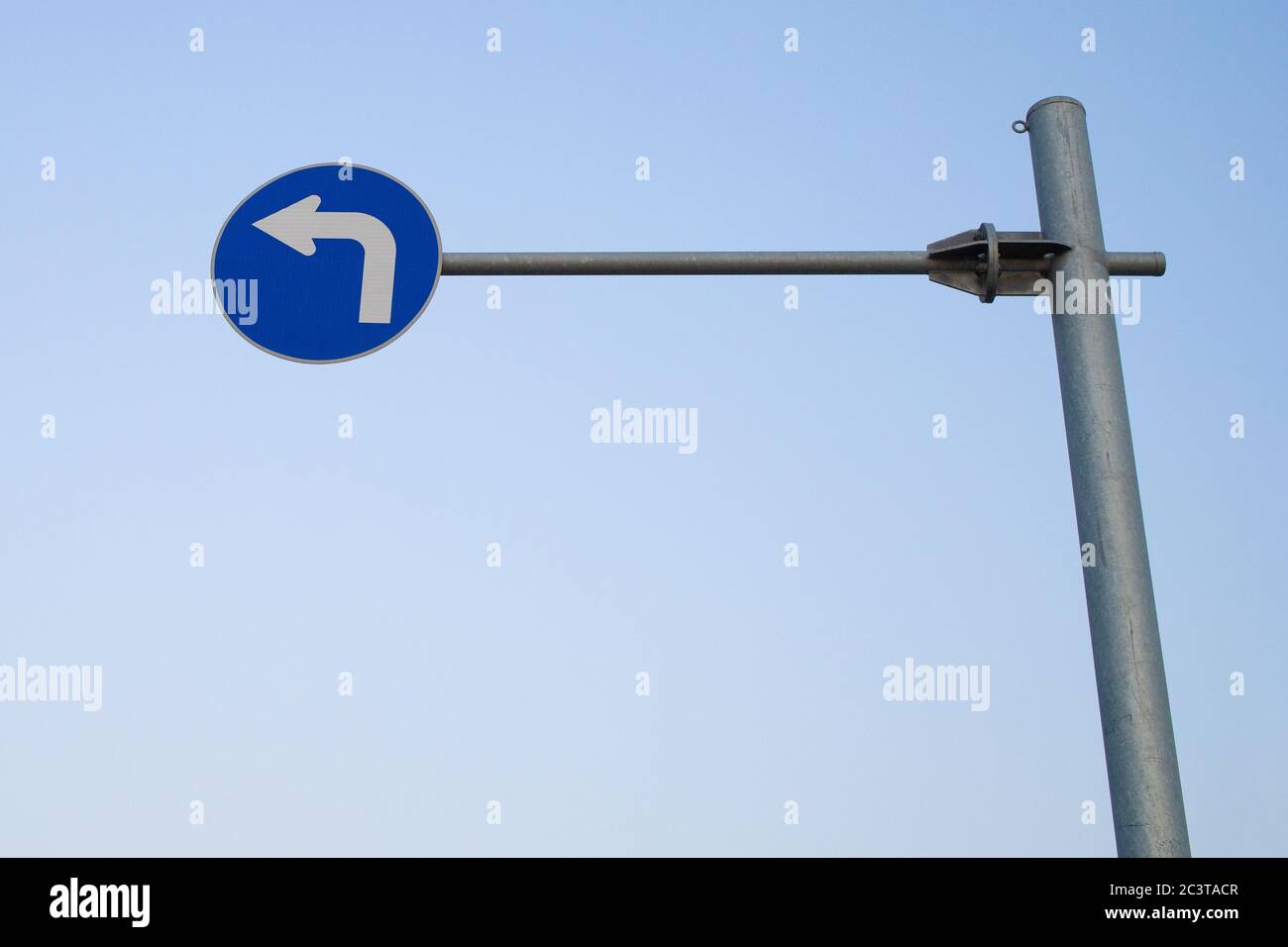 high hung blue left turn sign. Stock Photo