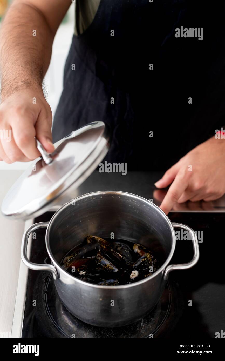 Cooking mussels and seafood in a cooking pot at home Stock Photo Alamy