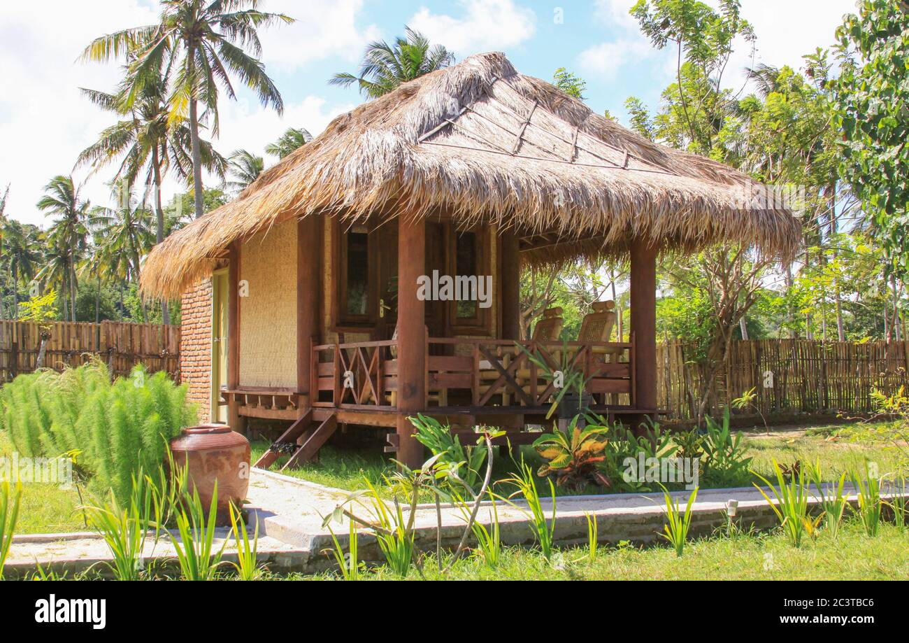 Sasak bamboo house and garden in Lombok resort, Indonesia. Kuta Lombok is an exotic paradise on the Indonesian island, with beautiful white sand beach Stock Photo