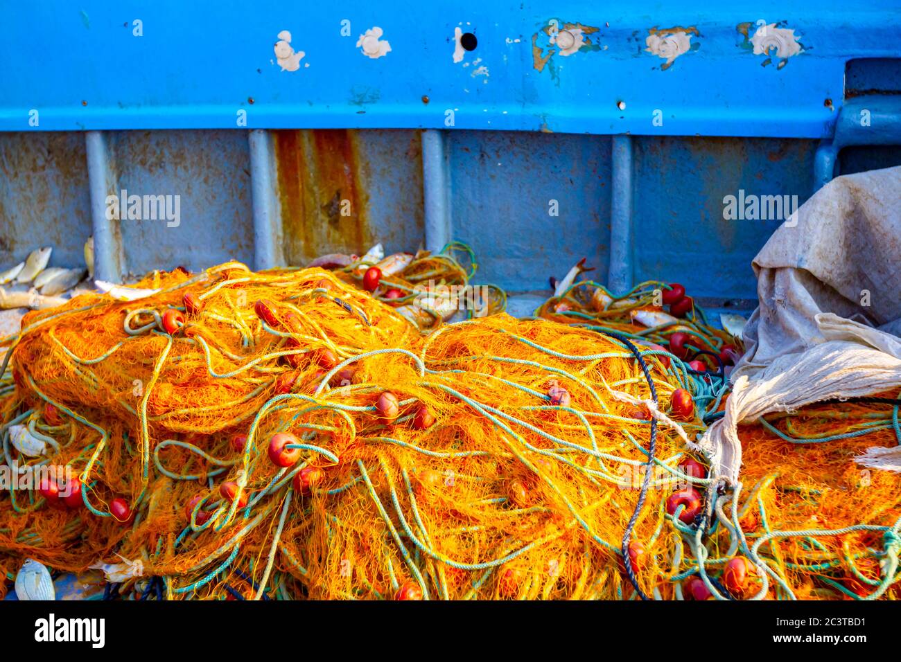 https://c8.alamy.com/comp/2C3TBD1/fisher-in-rubber-trousers-and-boot-siting-in-his-boat-and-pile-up-fishing-net-for-angling-at-open-sea-2C3TBD1.jpg