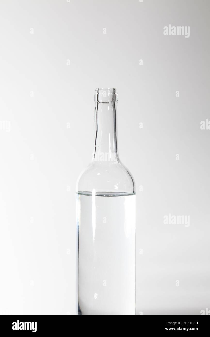 Clear Glass Bottle Water Against Grey Stock Photo