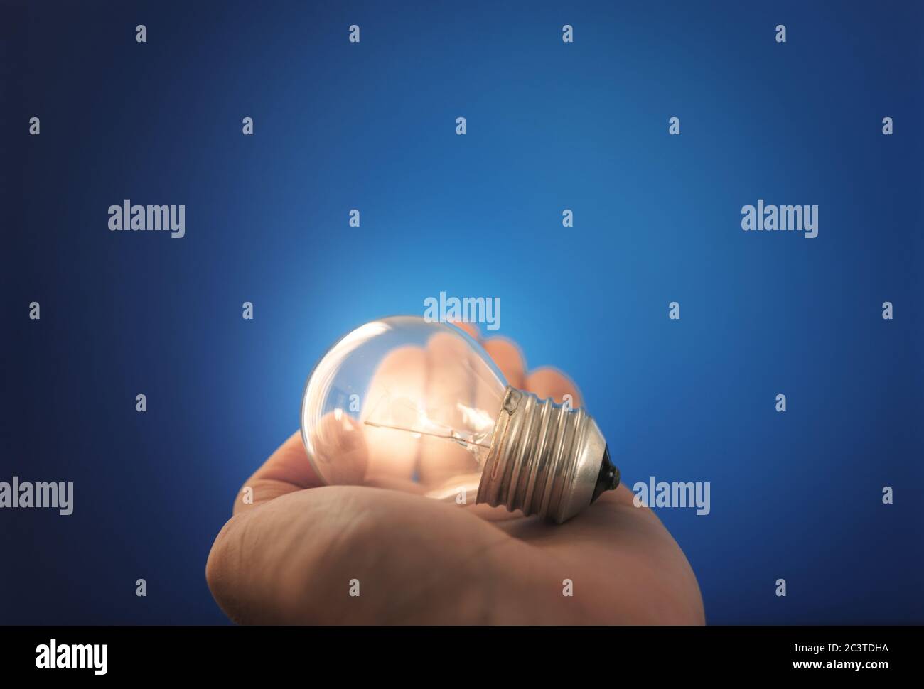 New ideas, innovation and inspiration concept. Glowing light bulb on hand Stock Photo