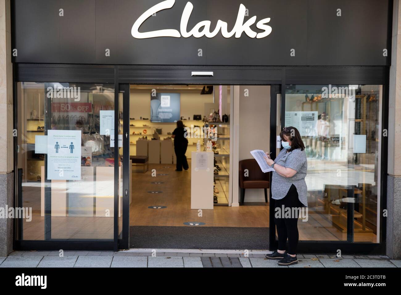 Cardiff, UK. 22nd June, 2020. A of staff wearing PPE outside a store as some non-essential shops reopen in Cardiff city centre following the lockdown. Credit: Mark Hawkins/Alamy