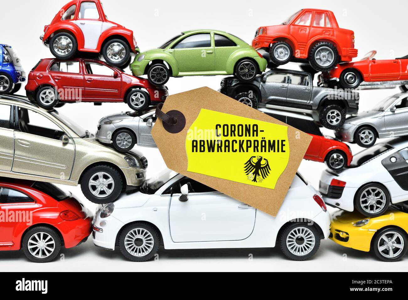 PHOTOMONTAGE, stacked toy cars with label and the label corona Abwrackprämie, FOTOMONTAGE, Gestapelte Spielzeugautos mit Etikett und der Aufschrift Co Stock Photo