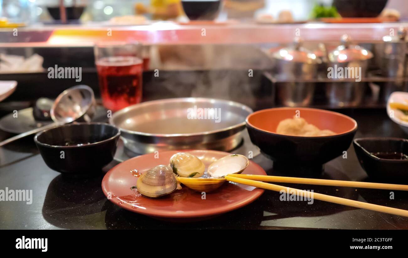 Unlimited buffet. Boiled shells in a plate against the background of a ...